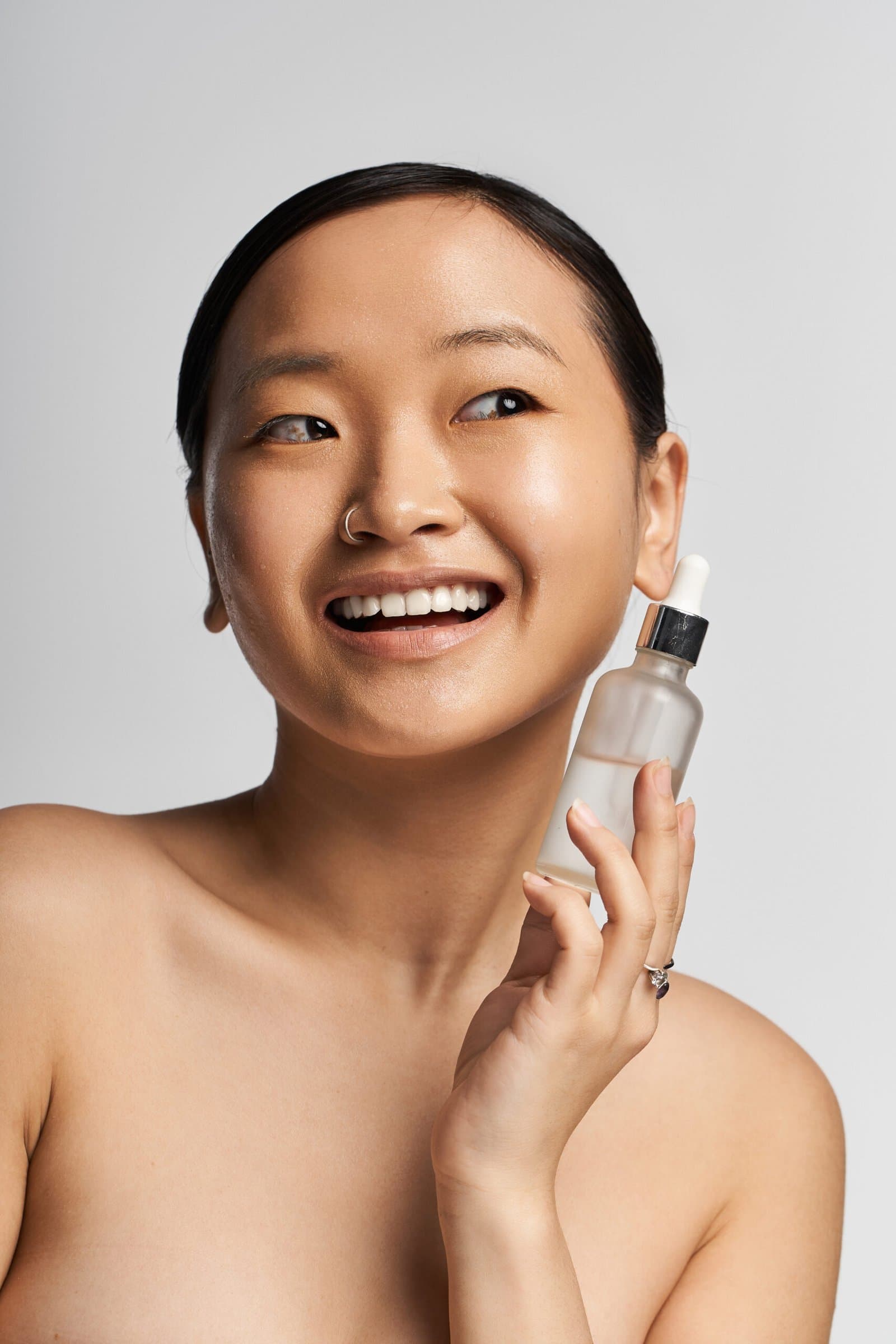 Model beside a pair of skincare products